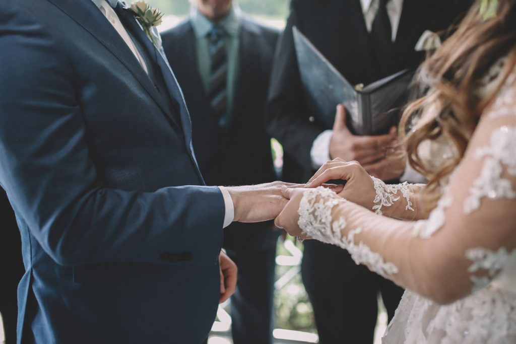 summer wedding central park ladies pavilion brazilian couple putting his ring on